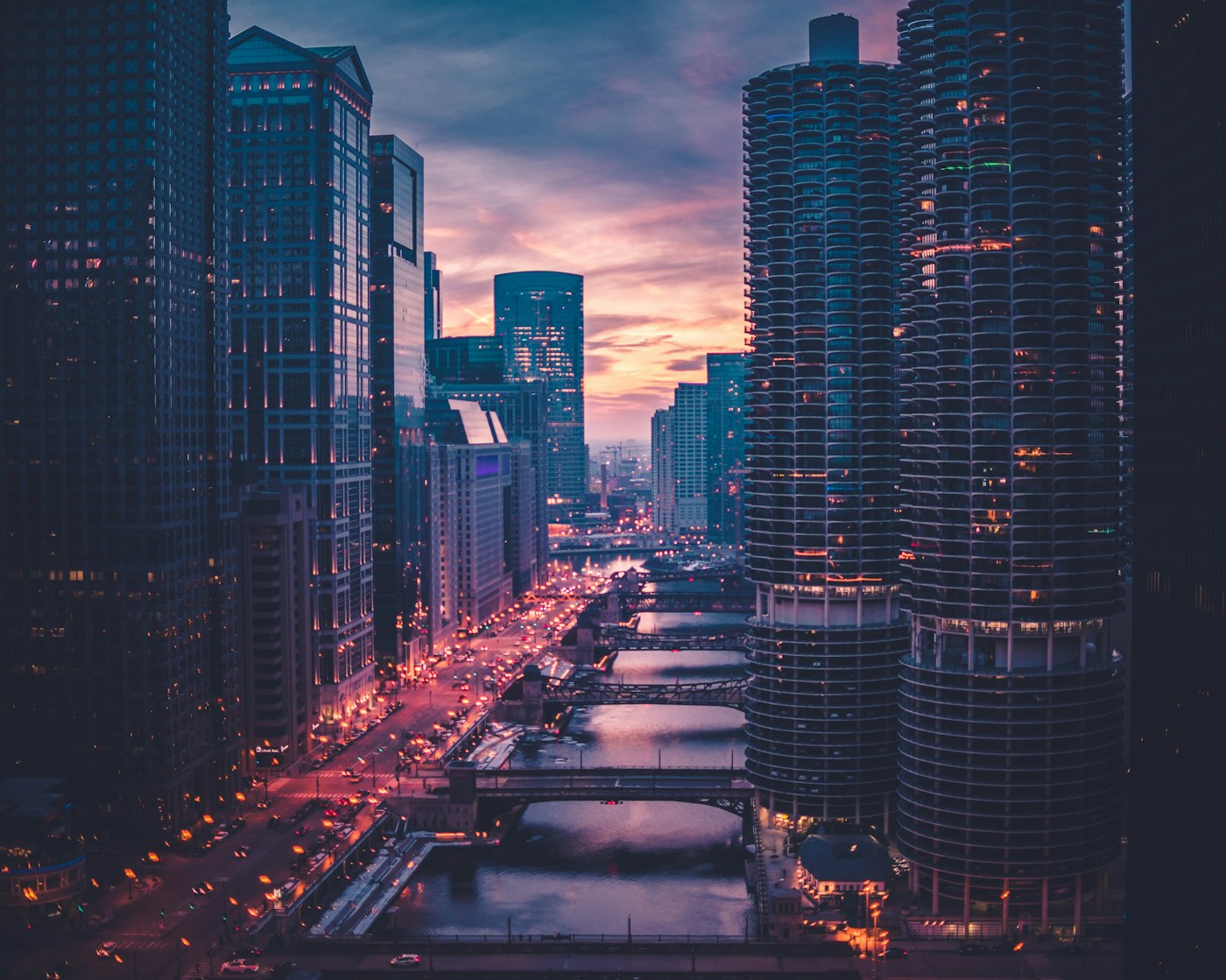 Luxury business district with illuminated towers and road traffic